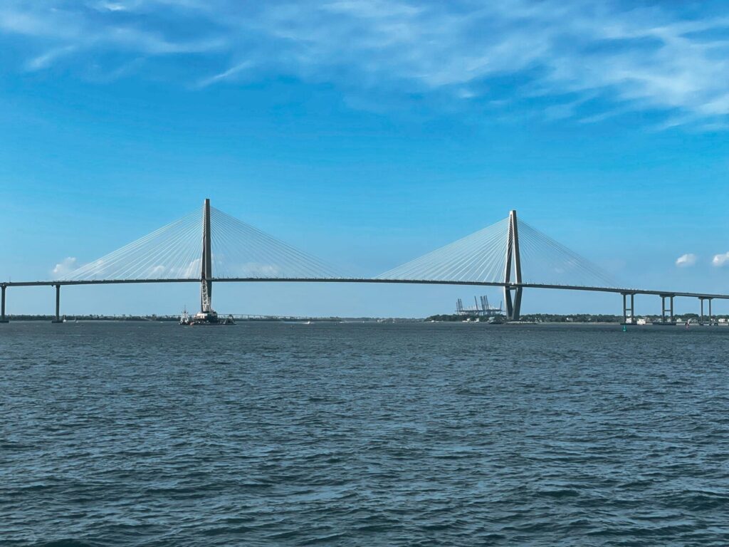 Large bridge spanning over water with two diamond shapes on it.